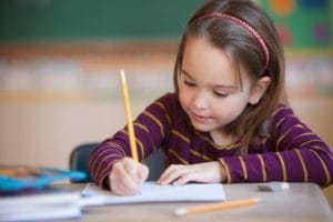 Caucasian girl studying in classroom